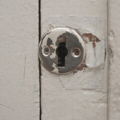 The keyhole on the old painted door