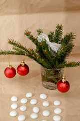 New Year's composition with Christmas tree branches, red balls for the Christmas tree and a silver bow