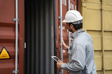 Man logistics workers use tablet computer with container background	