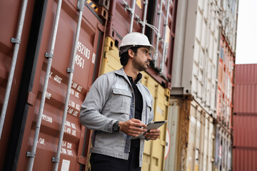 Man logistics workers use tablet computer with container background	