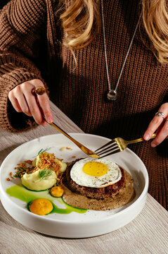 beefsteak with sauce and fried eggs