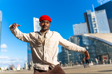 Young black man dancing in urban city environment