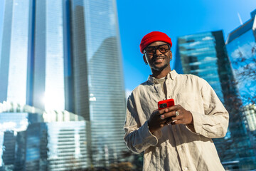 Young man connecting with smartphone in urban city