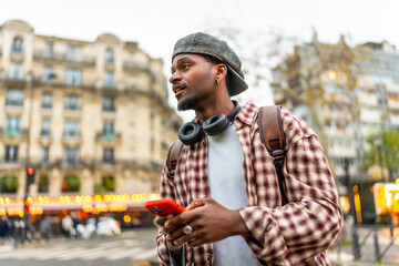 Young man using smartphone traveling in city street