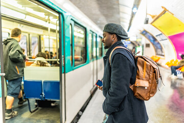 Fototapeta premium Young man commuting in urban subway station platform