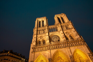 Notre dame cathedral illuminating paris night sky