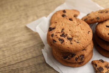 Delicious chocolate chip cookies on wooden table, closeup. Space for text