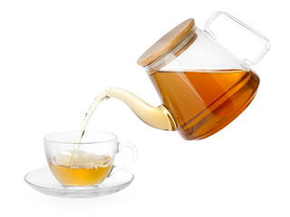 Pouring hot tea into cup from teapot on white background
