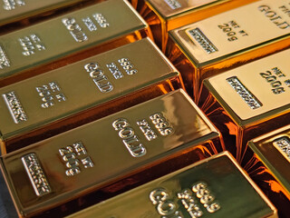 Gold bars stacked in a neat arrangement showcasing their shiny surface and weight specifications concept