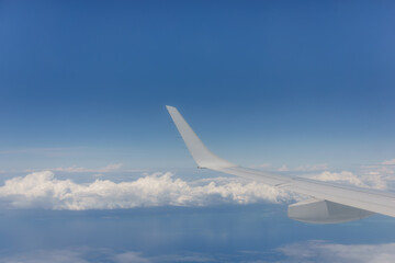 Through plane window blue sky and white cloud background image