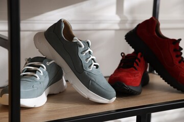 Shoe storage with different footwear in store, closeup