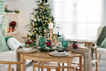 Festive table setting with Christmas decor indoors