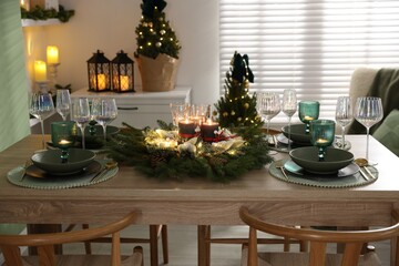 Festive table setting with Christmas decor indoors