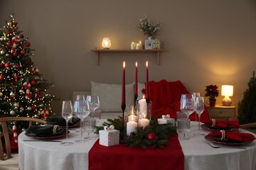 Festive table setting with Christmas decor indoors