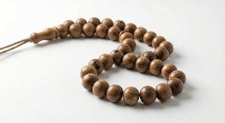 Obraz premium Realistic wooden tasbih prayer beads arranged in a curved shape