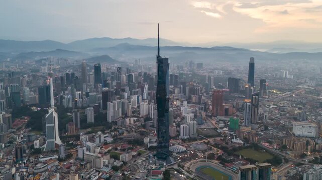 Aerial view time lapse 4k video of Kuala Lumpur city center view during dawn sunrise overlooking the city skyline in Federal Territory, Malaysia. Pan right