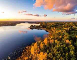 Aerial view of lake bordered by autumn forest at sunset