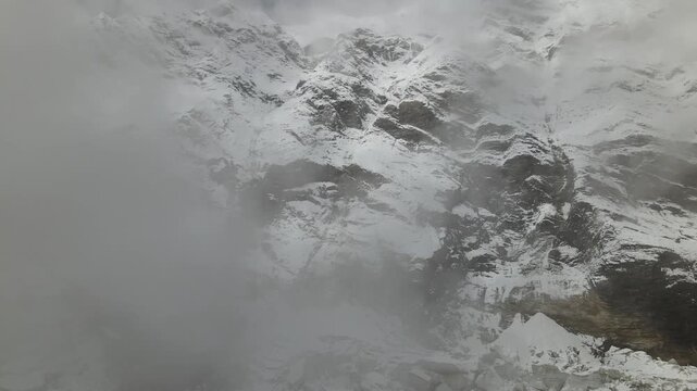 Drone footage showcases Manaslu Base Camp below the 8,163m Himalayan peak. The scene reveals snowy ridges, rugged terrain, and the dramatic high-altitude environment of this remote mountain region.