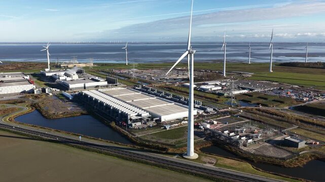 Aerial drone video showcasing the ongoing expansion of a large-scale, high-tech hyperscale data center in Eemshaven, Netherlands, a critical infrastructure hub for AI and computing power.