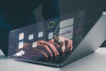 A person is using a laptop with a transparent overlay of data analytics and graphs, showcasing technology and data visualization.