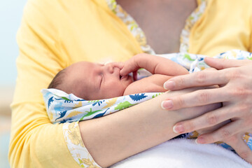 Fototapeta premium Mother, holding tenderly her newborn baby boy. Closeup portrait