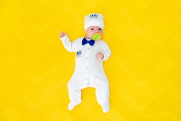 Portrait of baby boy on yellow background