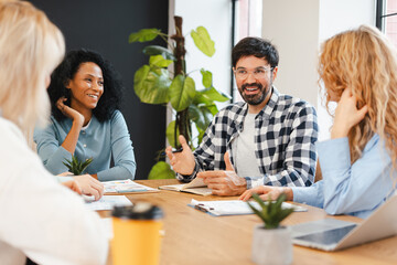 Diverse business team collaborating during a casual meeting in a modern office