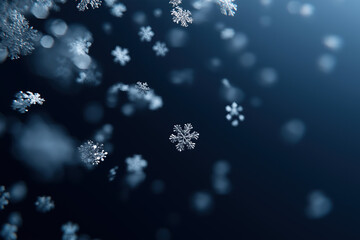
Delicate snowflakes descending through atmospheric blue bokeh creating wintry scene.