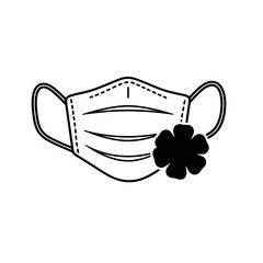 Medical face mask with a clover leaf silhouette isolated on white background