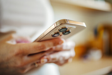 Person holding modern smartphone communicating