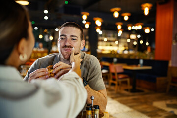 Young couple enjoying a romantic dinner date at restaurant