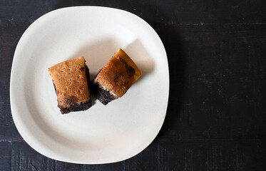 Sliced chocolate and cheese layered cake on plate, Indonesian food 