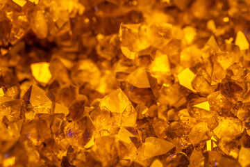 Golden crystal mineral stone. Gems. Mineral crystals in the natural environment. Texture of precious and semiprecious stones. Seamless background with copy space.