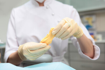 Material for making dental casts. The doctor holds in his hands a mass for making dental casts. A...
