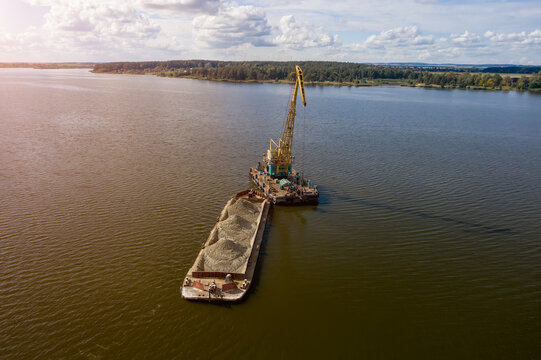 Cleaning the river bottom with a crane and a barge top view