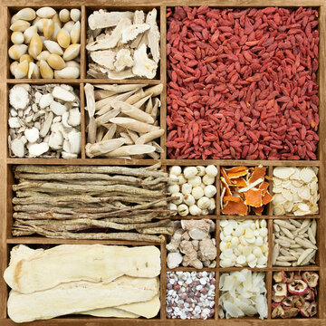 Diverse Chinese herb medicines in a rustic wooden box