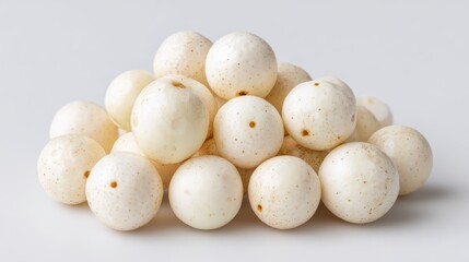 Fototapeta premium Elegant Lotus Seeds Pile: A pristine collection of delicate lotus seeds, with their smooth, creamy exteriors, form a captivating display, representing a taste of purity and natural goodness.