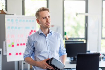 Business employee with VR glasses in modern office environment