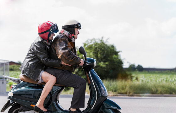 Couple riding scooter outdoors enjoying active and fun adventure