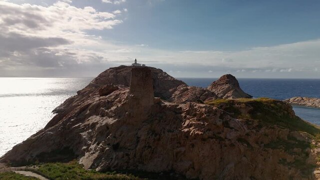 Smooth Aerial Drone Orbit Shot Circling the Historic Genoese Defence Tower on the Rugged Pietra Peninsula, L'&Icirc;le-Rousse, Corsica, France.