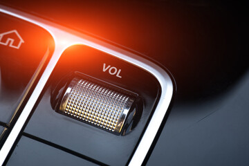 volume button on the panel of a modern car