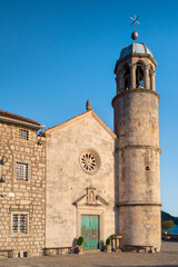 Fototapeta premium The church of our lady of the rocks in Perast at sunset. Bay of Kotor. UNESCO Natural and Culture Historical Region. Montenegro.