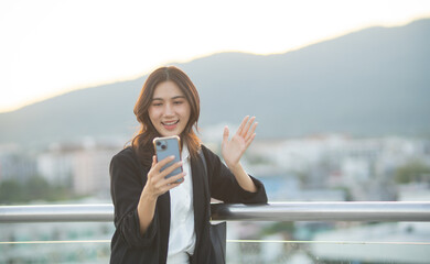 Confident Asian businesswoman smiling in a modern corporate setting, attractive professional lady standing outdoors, showcasing success, beauty, career ambition, and cheerful lifestyle.