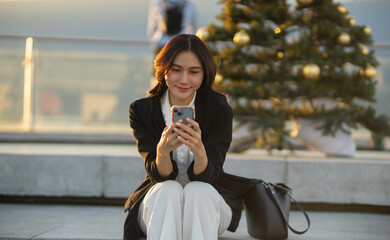 Confident Asian businesswoman smiling in a modern corporate setting, attractive professional lady standing outdoors, showcasing success, beauty, career ambition, and cheerful lifestyle.