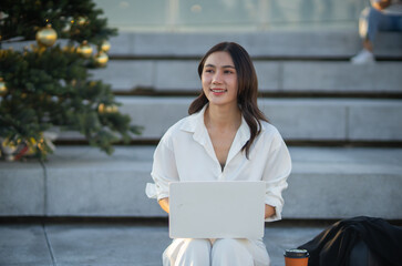Confident Asian businesswoman smiling in a modern corporate setting, attractive professional lady standing outdoors, showcasing success, beauty, career ambition, and cheerful lifestyle.