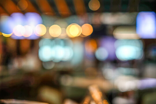 A warm and soft bokeh background captured inside a modern cafe, featuring blurred lights and abstract shapes. Perfect for banners, lifestyle promotions, or templates cozy and atmospheric backdrop
