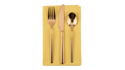 Isolated gold cutlery setting on a yellow fabric napkin, dining presentation for modern dinner