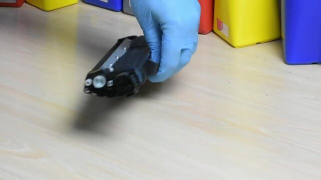 Toner cartridge lifted from a laser printer on a wood desk, smooth swap and crisp clicks highlighting simple, hands on maintenance in a tidy workspace