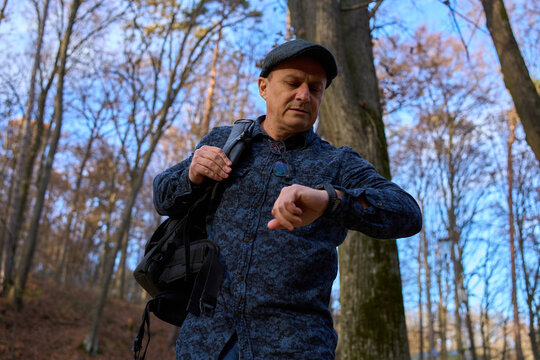Man checking time on smartwatch in park