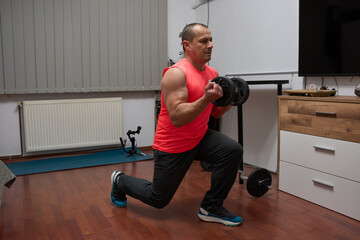 Man doing lunges with dumbbells at home